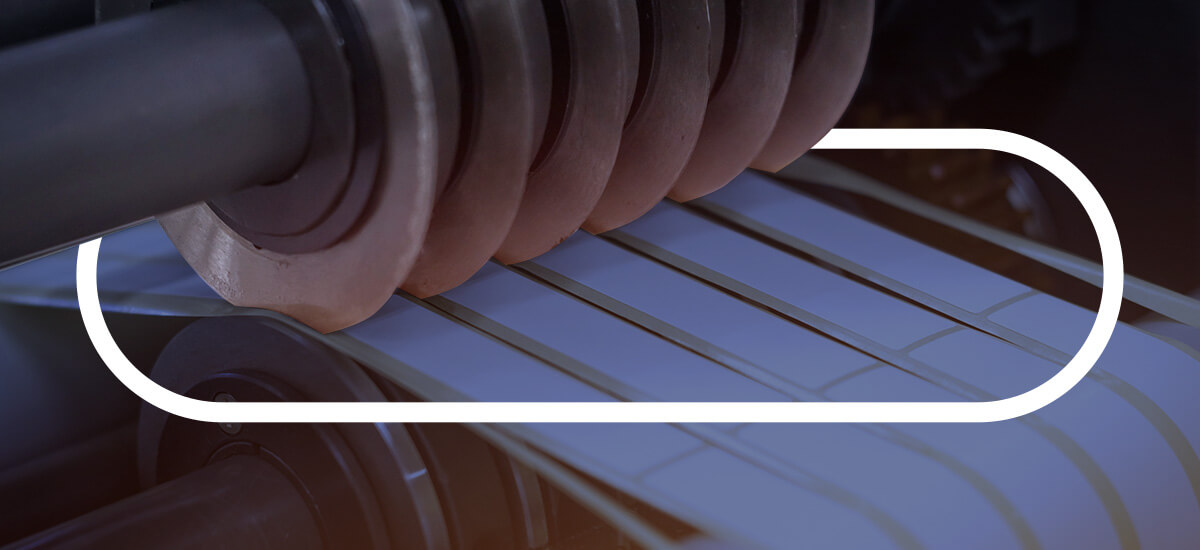 round industrial blades cutting through adhesive material