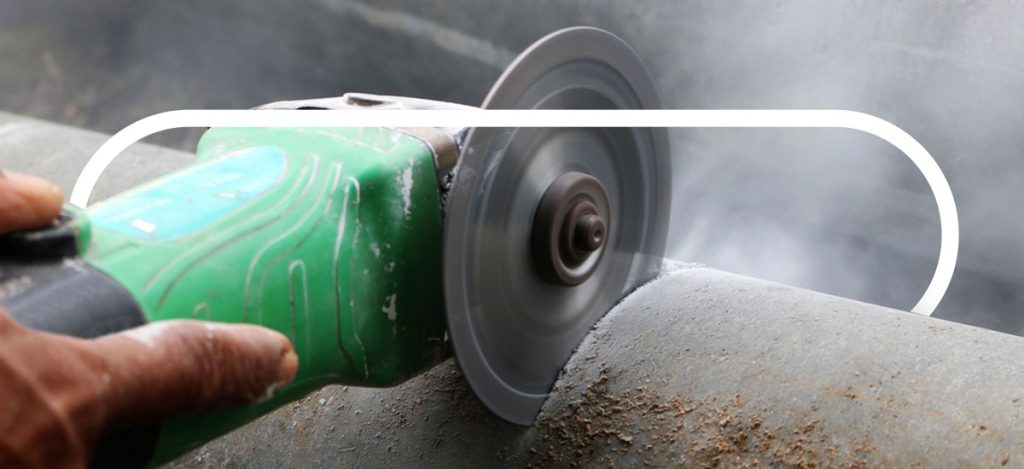 handheld device with circular blade cutting into foam-like material